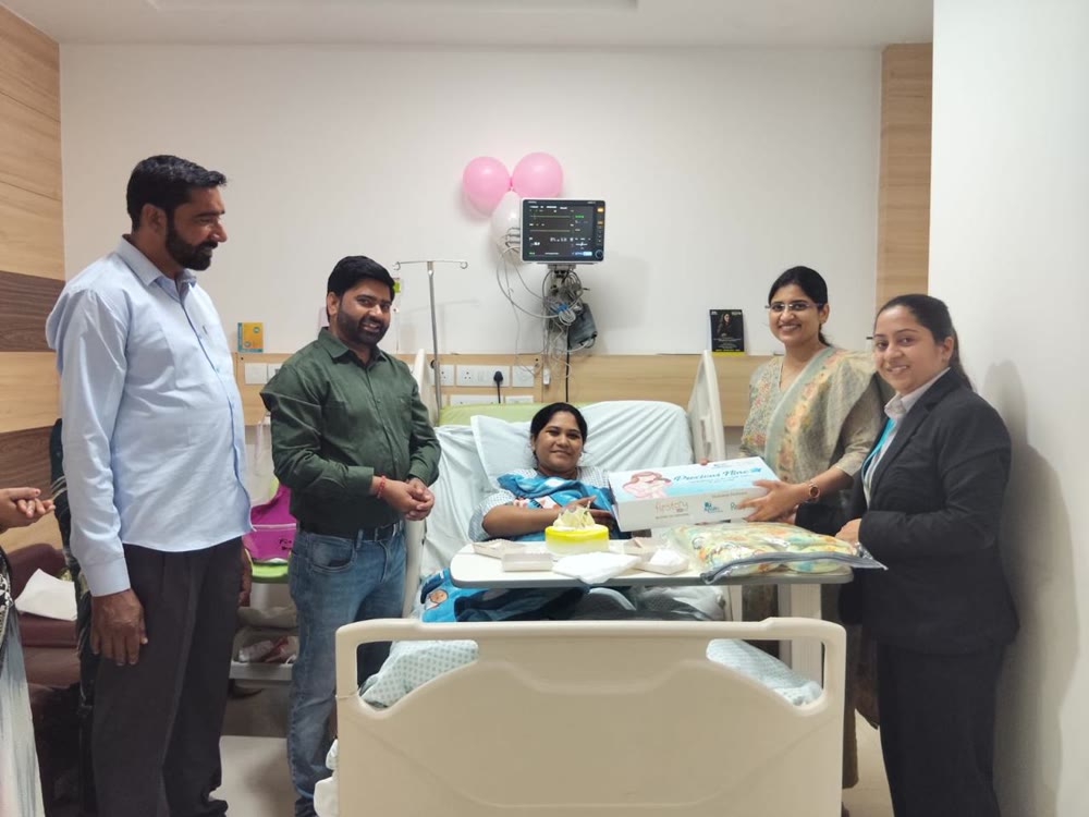 Dr. Asna Zehra Naqvi celebrating a safe delivery with a new mother and family